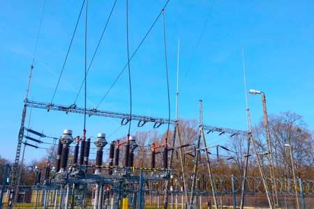 Transformer station close-up. Power lines against the blue sky