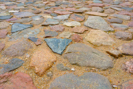 Laid stones on the ground for walking in the old partの写真素材