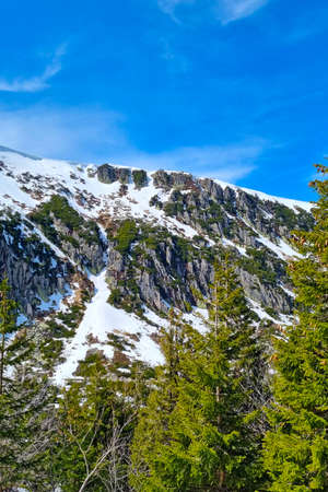 The tops of the mountains with snow against the blue skyの写真素材