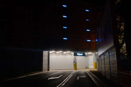 Wroclaw, Poland, October 15, 2021: Night illumination of a shopping center with a sign of entry and exit to the parking lotのeditorial素材