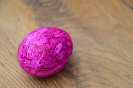 A pink egg is on the table. Preparing for Easter. Spring Festival.の写真素材