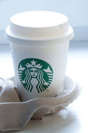 Wroclaw, Poland, May 15, 2021: A mug of delicious and hot Starbucks coffee. Starbucks is an American coffee company and coffee shop chain of the same name.のeditorial素材