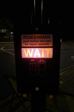 London, United Kingdom, February 7, 2022: pointer to the other side of the street. Crosswalk. Waiting inscriptionのeditorial素材