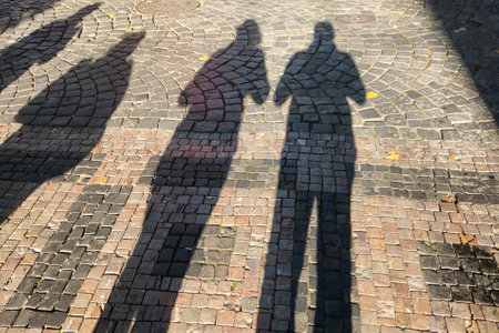View of the shadows of people on the ground or city tilesの写真素材