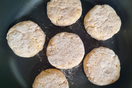 A frying pan with cheesecakes. Cooking from cottage cheeseの写真素材