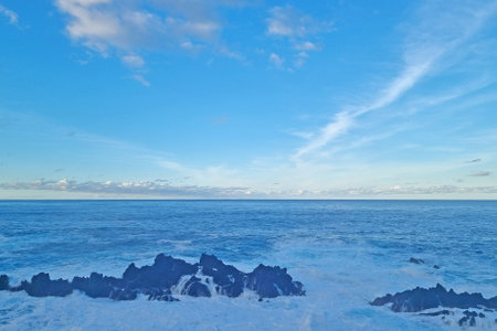 View of the waves of the Atlantic Ocean and the blue skyの写真素材