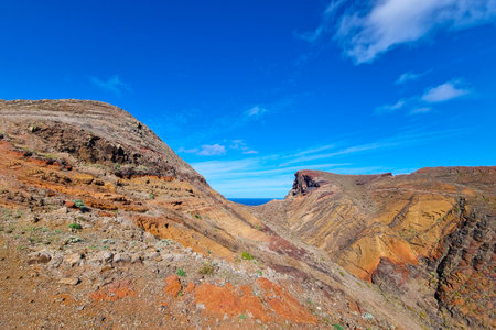 Bright rocks of mountains on an island in the oceanの写真素材