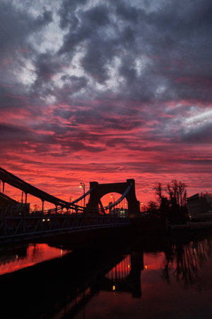 Wroclaw, Poland, August 10, 2022: picturesque and dramatic sunset on the bridge in Wroclaw.