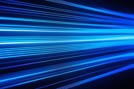 Blue light streaks on a black background. The streaks are of varying thickness and opacity, and they appear to be moving in a random pattern. The background is a solid black color.の素材