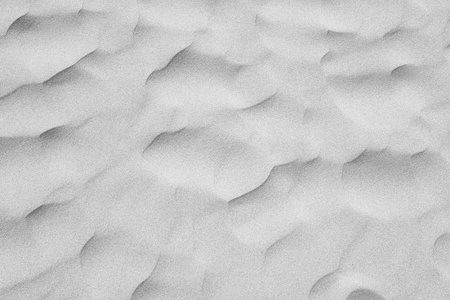 Abstract close-up view of gently undulating snow dunes. the intricate natural patterns form a...