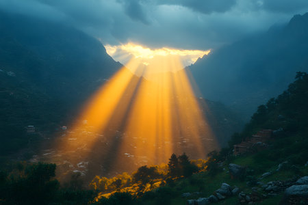 Stunning sunrays pierce through dense clouds over mountainous terrain at sunset, creating a dramatic and serene landscape. the play of light and shadow accentuates the lush greenery and rugged peaks below. Generative AIの素材