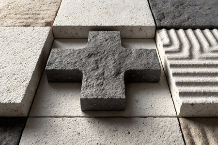 Textured stone tiles form a captivating geometric pattern featuring a central cross. the varying textures and shades of gray and white create depth, ideal for architectural design, interior decoration, and creative projects. Generative AIの素材