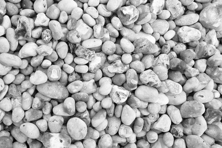 A monochromatic image showcasing a textured arrangement of variously shaped pebbles. this...