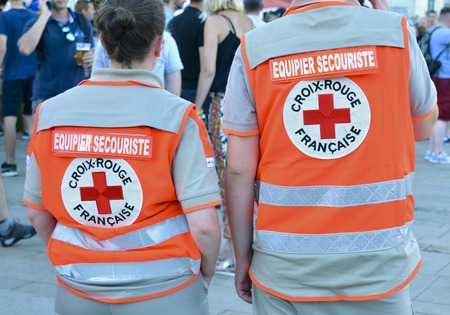 LE MANS, FRANCE - JUNE 16, 2017: Back of two people who work in French Red Crossa first aid team mates in France during parade of 24 hours of Le mansのeditorial素材