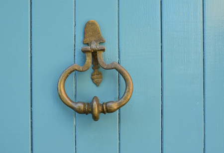 Blue handle door rusty iron ring in wood doorwayの写真素材