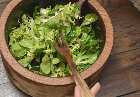 Wood bowl of fresh salad on a wooden tableの写真素材