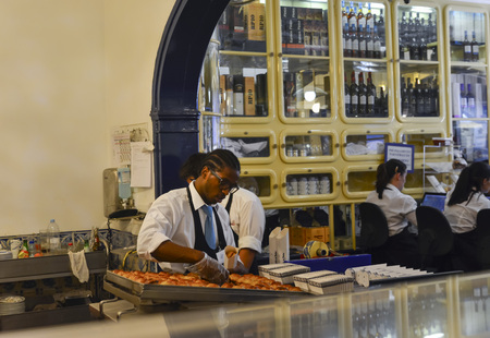 LISBON, PORTUGAL- AUGUST 07, 2017: The worker fills the boxes Pasteis de Belem in the historical...