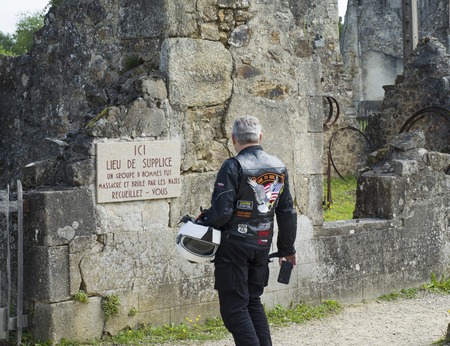 ORADOUR SUR GLANE, FRANCE - AUGUST 16, 2017: Tourists looks at the ruined building during World War 2のeditorial素材