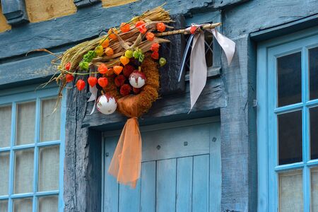Wreath of autumn plants with physalis wheat and christmas tree toyの写真素材