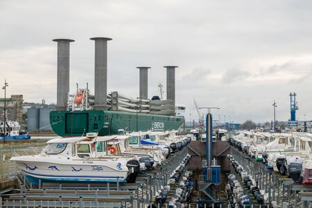 DIEPPE, FRANCE - DECEMBER 24, 2018: Maritime transport of wind turbine blades nd motor boat parking at a port of Dieppeのeditorial素材