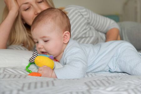 Mother looks at the child as he plays