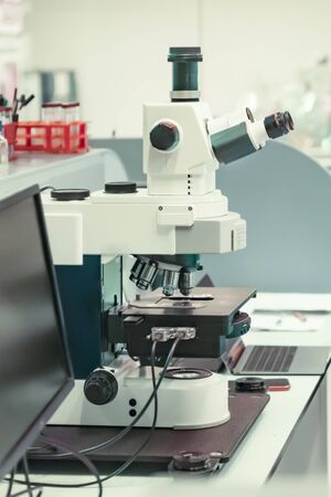 Microscope with metal lens at laboratory for developing vaccines against coronavirusの写真素材
