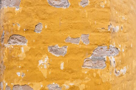 Yellow sand shabby broken wall background textureの写真素材