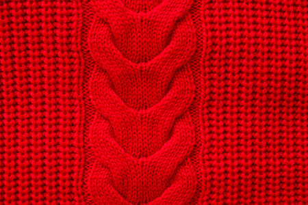 Red knitted winter sweater Background textureの写真素材