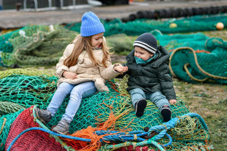 Brother and sister playing with fishing nets
