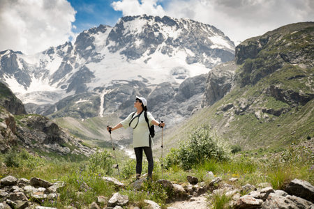 A woman with backpack in the mountains Caucasusの写真素材