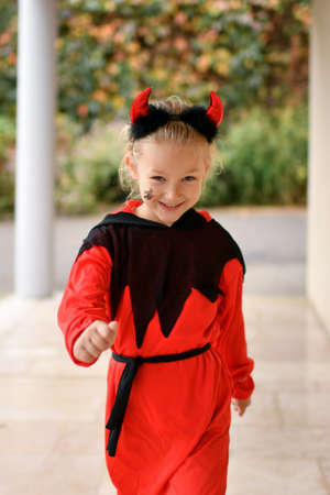 Scary girl dressed as a devil with hornsの写真素材