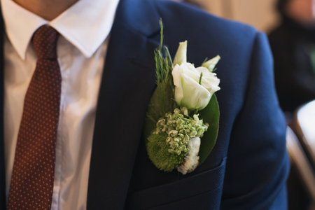 Groom with a buttonhole of white eustomaの写真素材
