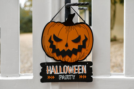 Carved pumpkin on the fence of the houseの写真素材