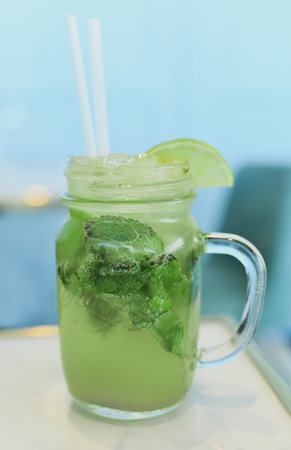 Mojito with lime and mint in a glass mugの写真素材