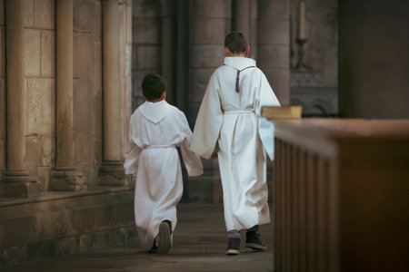 Children with white tunic dress during communion in the churchの写真素材