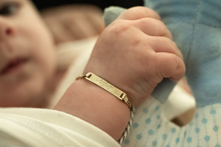 A child with a golden bracelet after the christening ceremonyの写真素材