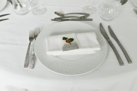 Table setting with cutlery and white napkinの写真素材