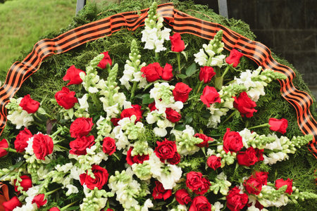 Basket with red rose and lily flowers Saint George ribbonの写真素材