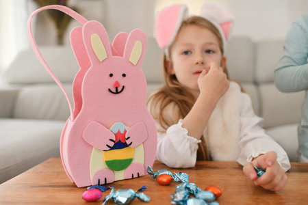 Girl with bunny ears and basket for chocolate eggsの写真素材