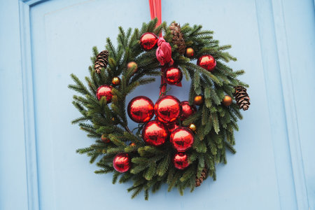 Christmas wreath with branches and red balls on a door Entranceの写真素材
