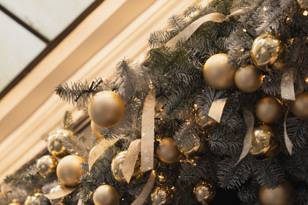 Christmas tree branches with golden balls and ribbonsの写真素材