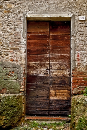 old door at fifty-nine in castell'arquato in italyの写真素材
