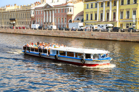 Saint Petersburg, pleasure boat with tourists sailing along the Fontanka river, summer day. Russia, Saint Petersburg July 2020のeditorial素材