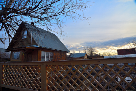 The morning light emphasizes the warm texture of the wooden fence.の写真素材