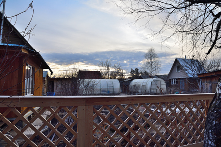 The morning light emphasizes the warm texture of the wooden fence.の写真素材