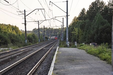 The train leaves and soon disappears around the bend.の写真素材