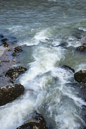 They begin their journey high in the mountains, merging with each other, and end their journey into the sea.の写真素材