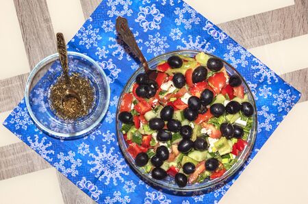 A variety of ingredients for the preparation of vegetable salad with cheese lie on the table.の写真素材