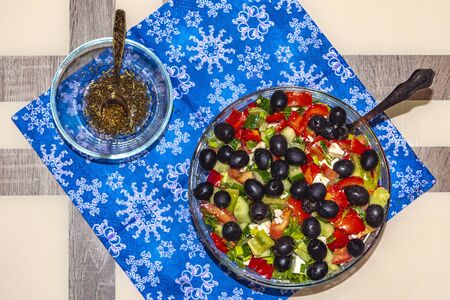 A variety of ingredients for the preparation of vegetable salad with cheese lie on the table.の写真素材
