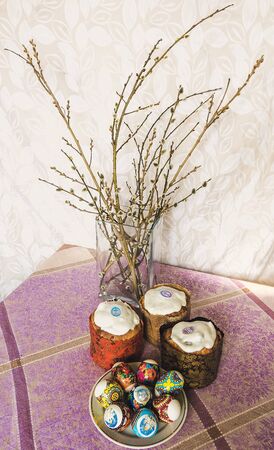 On the festive table are Easter eggs and a delicious cake, symbol of Easterの写真素材